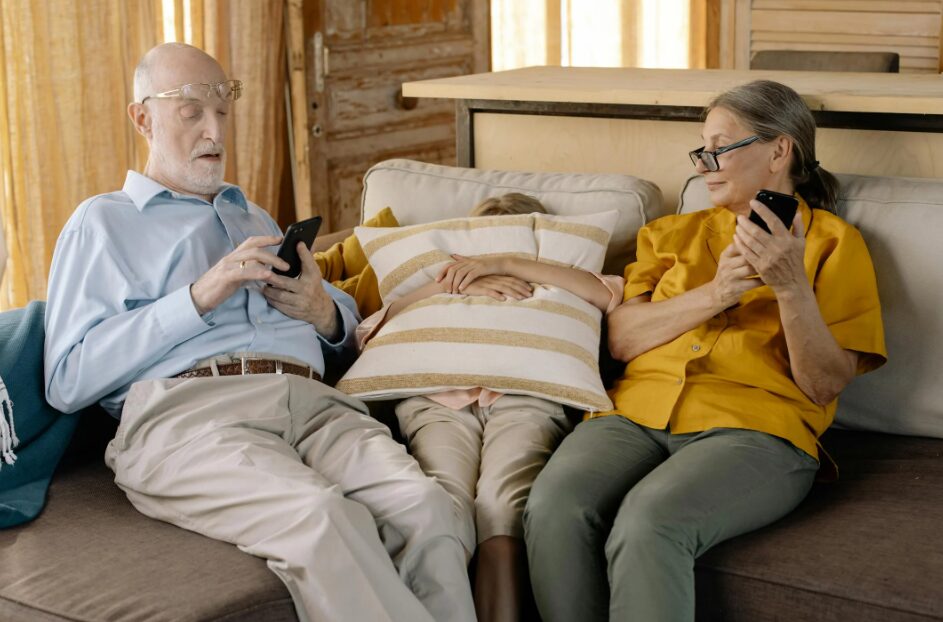 거실에서 노부부가 손자와 다정하게 휴식을 취하는 이미지